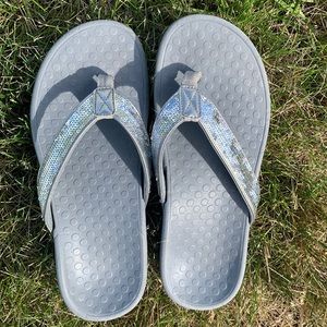 Vionic silver sequined flip flops.